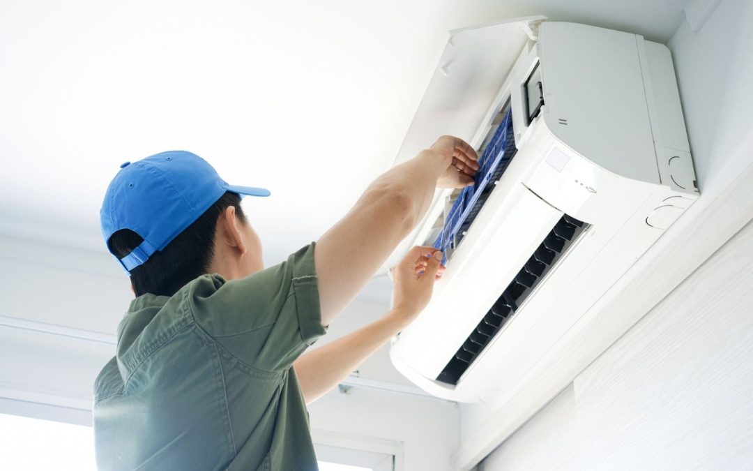 Air conditioning technician maintaining an indoor mini split system in Mesa, AZ
