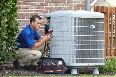 HVAC technician inspecting an outdoor air conditioning unit in Mesa, AZ